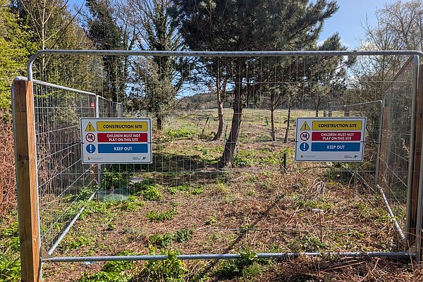 Photo of field with trees with HERAS fencing in the foreground