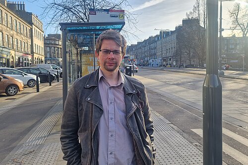 Jack standing in front of a bus stop