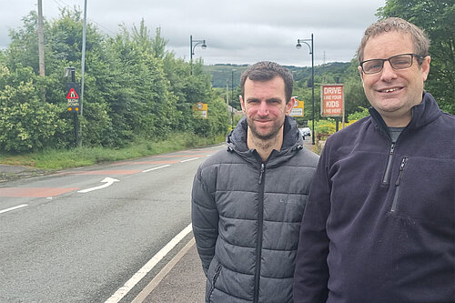 Councillors Michael Powell and Garth Harkness at the side of the road in Denshaw where they have requested speed cameras