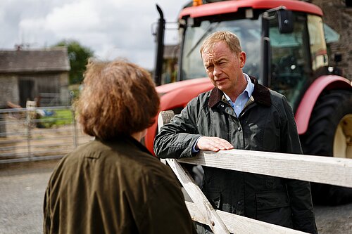 Tim talking to a farmer