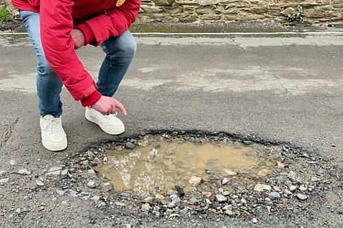 Richard shows a pothole 